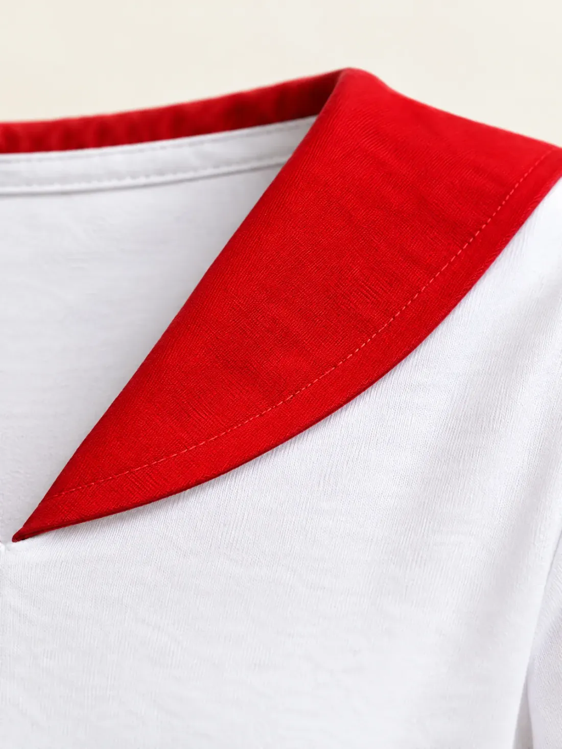 Beacon Red Collar Tee, close-up of the signal-red collar flap lying on the white jersey at the back