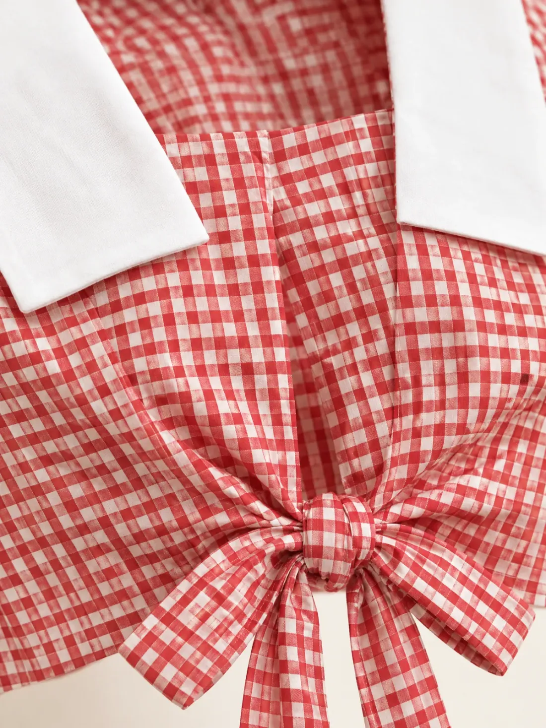 Cabin Gingham Sailor Top, close-up of the gingham check fabric meeting the white collar, and the knotted front ties