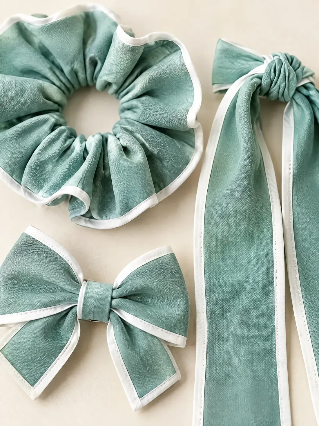 Harbour Hair Set of Three, close-up of the three pieces side by side showing white trim on sea glass