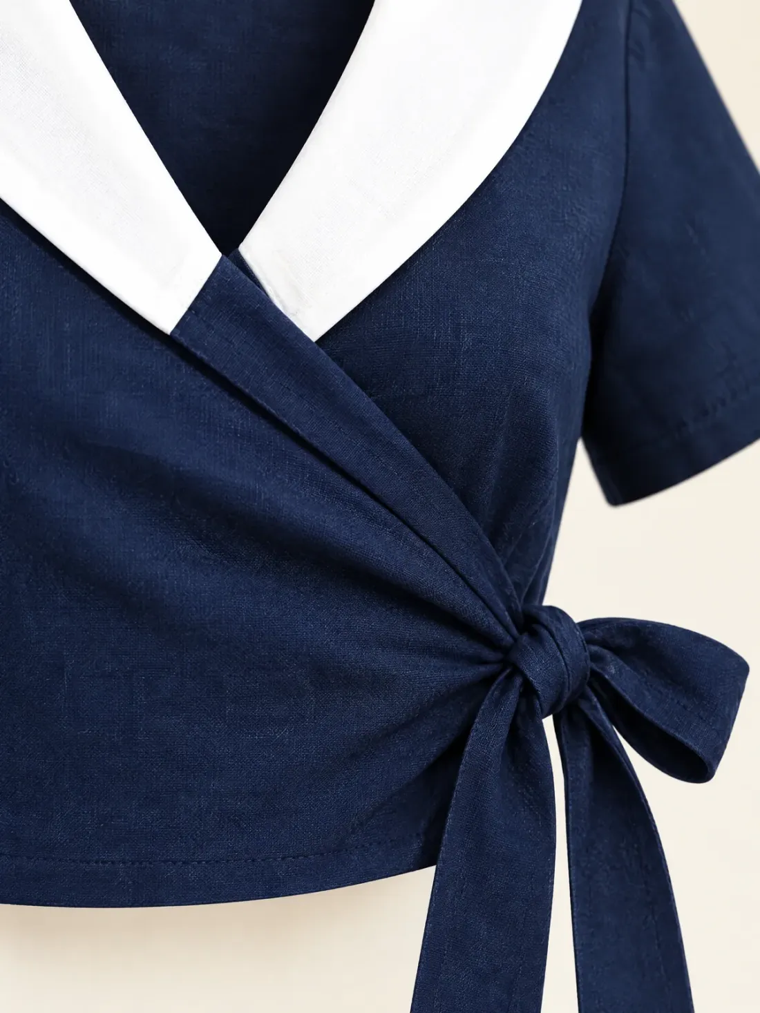 Jetty Wrap Sailor Top, close-up of the crossover wrap front and the side tie bow at the waist