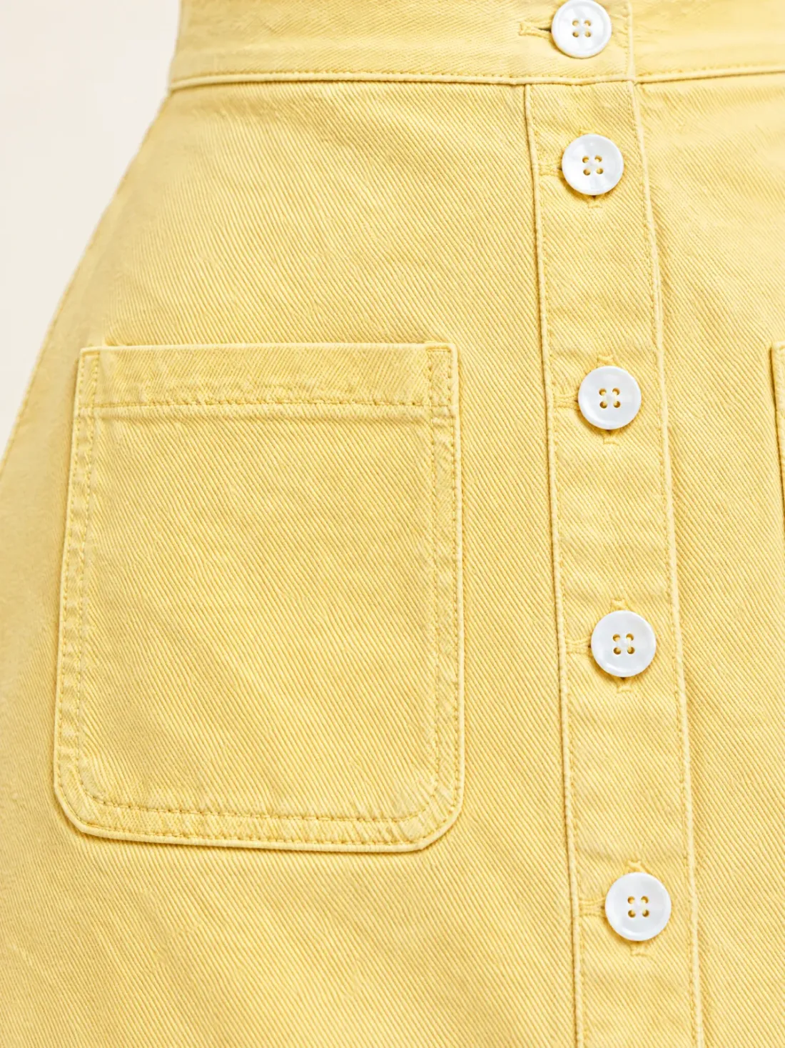 Keel Button-Through Mini, close-up of the square patch pocket and the white button line