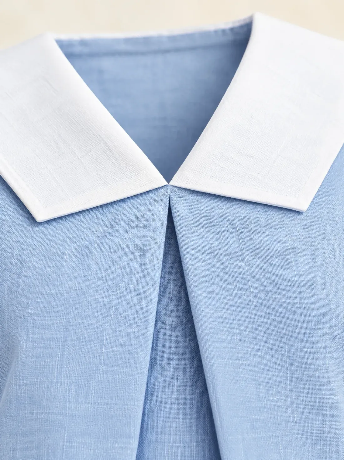 Marina Pleat-Front Sailor Top, close-up of the inverted box pleat at the centre front below the white collar