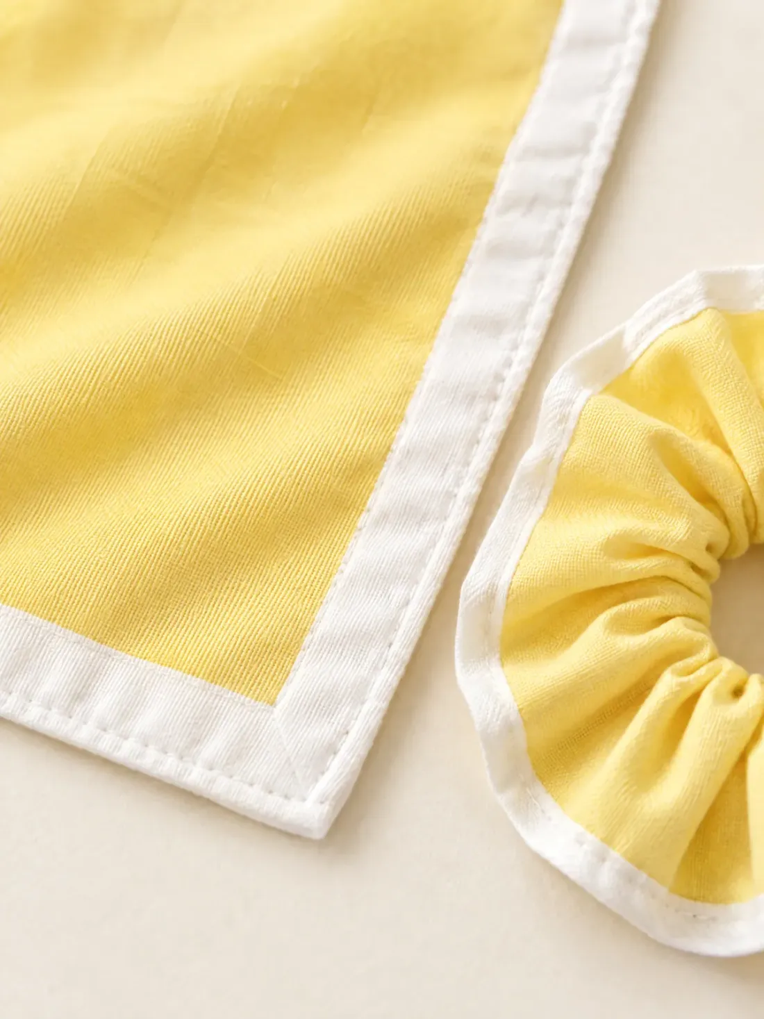 Neckerchief & Scrunchie Pair, close-up of the white-bordered neckerchief corner beside the matching scrunchie