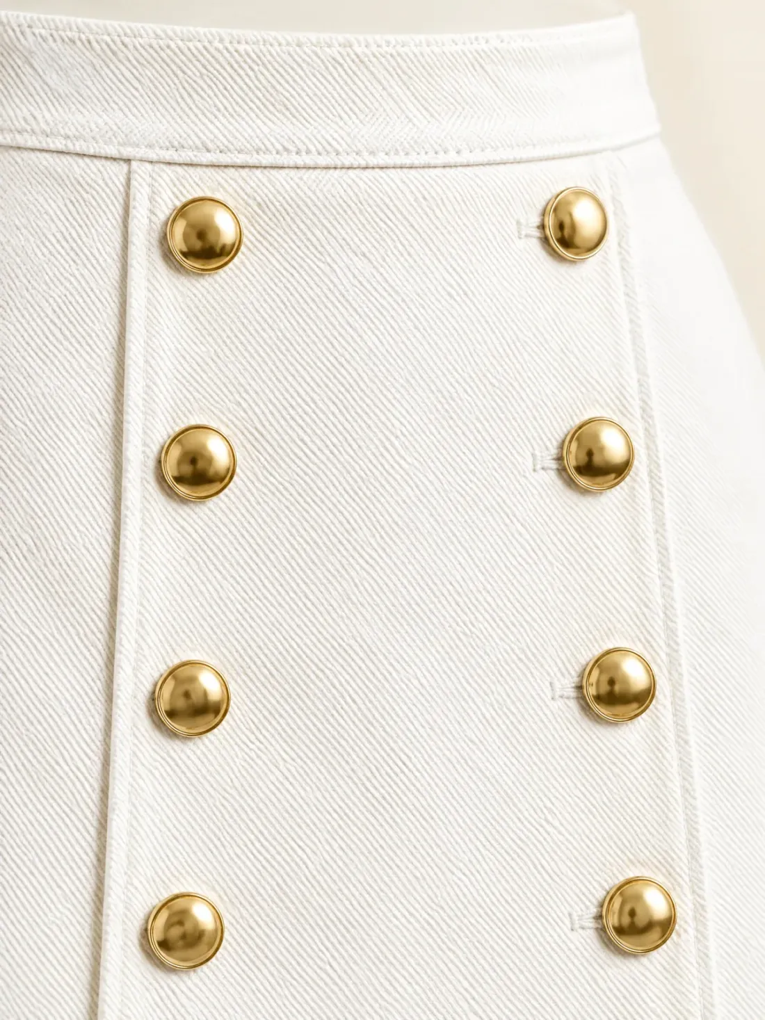 Promenade Double-Button Mini, close-up of the two vertical rows of gold-tone buttons on the raised front panel