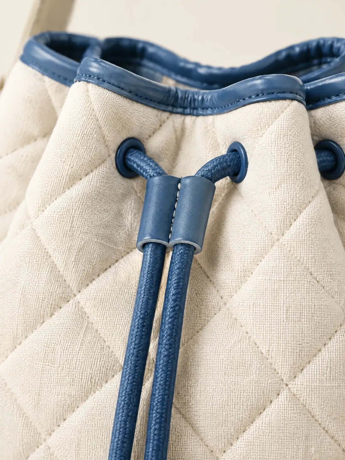 Tidewater Quilted Bucket, close-up of the diamond quilting and harbour-blue piping at the top edge